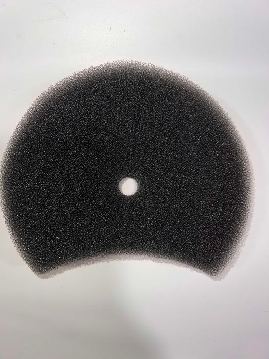 Replacement black foam dryer filter with a central hole and curved lower edge.