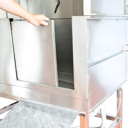 Hand opening the stainless steel dog bath's sliding access door above the ramp.