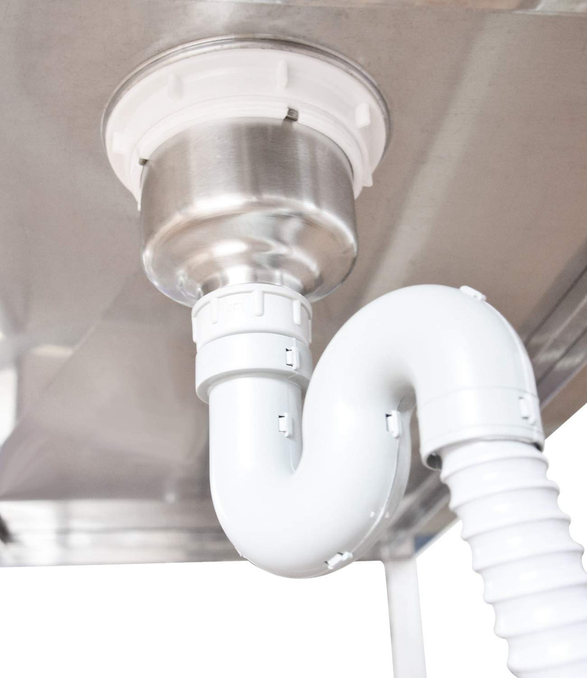 Underside of the dog bath showing the drain fitting, waste trap and flexible drain hose.