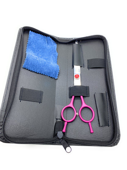 Purple-handled scissors secured inside an open black case with a blue cleaning cloth.