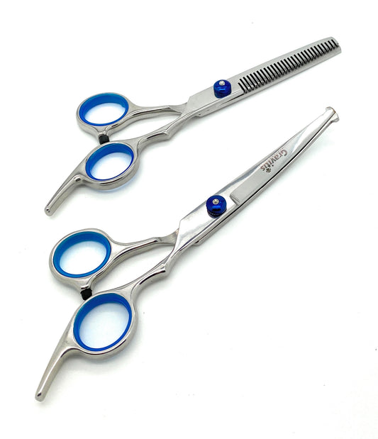 Curved grooming scissors and thinning shears with blue finger inserts.