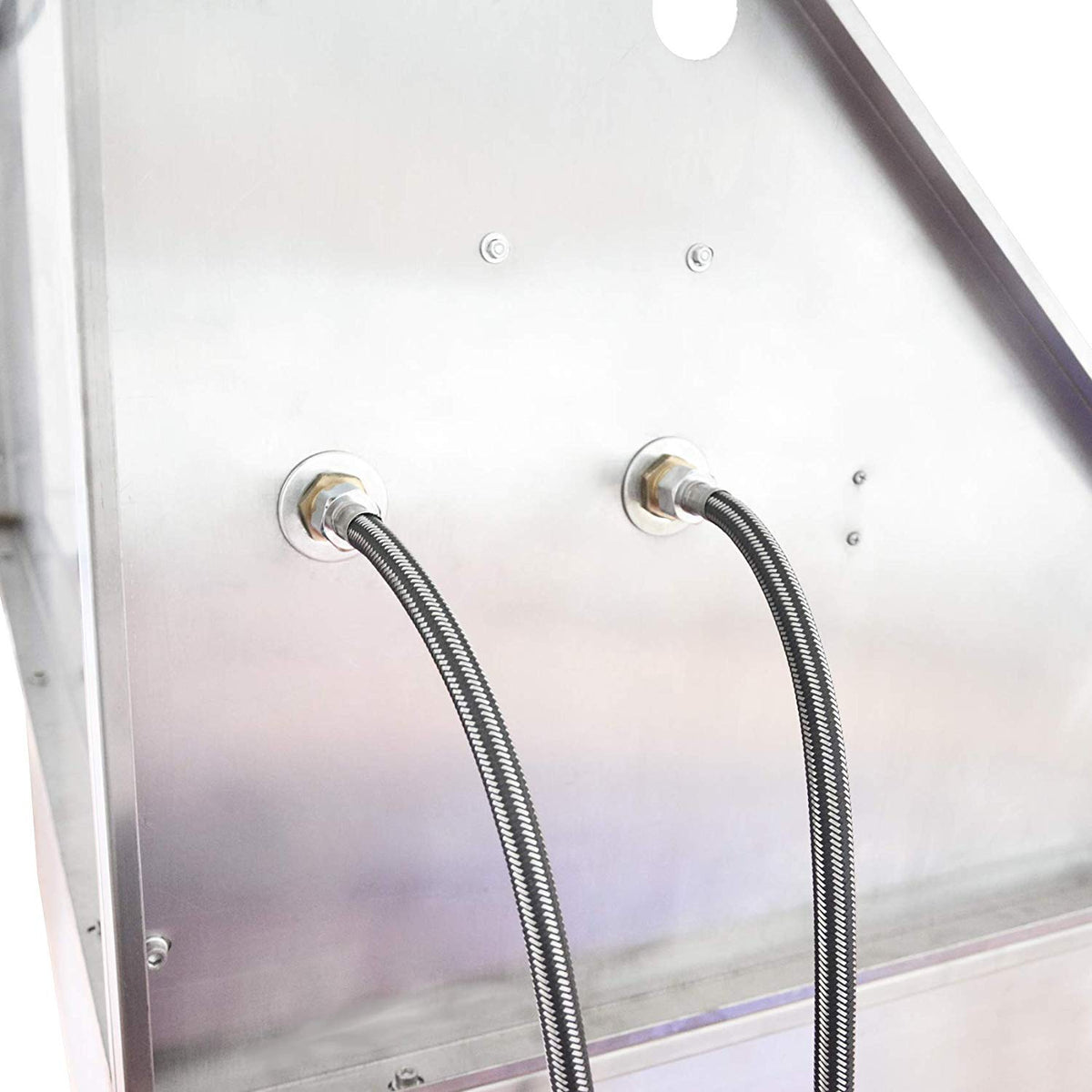 Two flexible water supply hoses connected to the back of the dog bath.